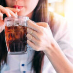 SHOCKING Study Reveals Diet Soda Betrayal Person drinking soda from a glass mug